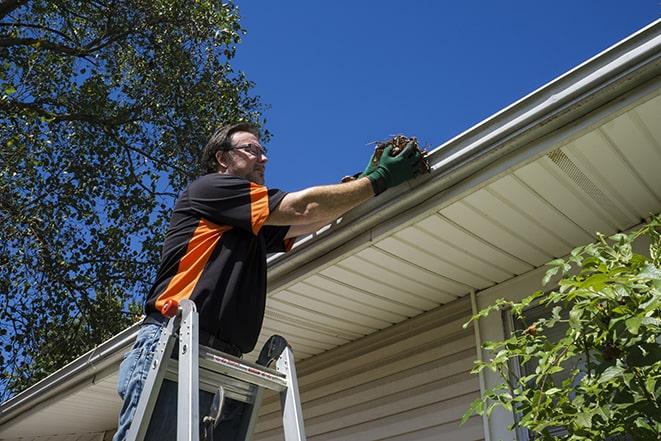 a gutter repair specialist working on a home in Bloomfield